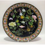 A cloisonné dish, foliate decorated with a butterfly upon a black ground, diameter 30cm