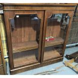 Victorian mahogany low glazed bookcase, the moulded top over a pair of glazed doors enclosing