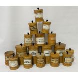A set of seventeen painted apothecary pots, the lids and bases pine, the cylindrical bodies