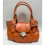 A Jimmy Choo orange leather handbag with silver fittings, with both interior zipped pocket and top