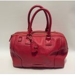 A Jaeger red leather ladies handbag with interior zipped compartment, top zip fastening, brown