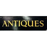 ANTIQUES sign with gilt painted lettering on a black ground, width 120cm