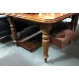 A Victorian mahogany extending dining table with two extra leaves, raised on turned and fluted