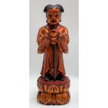 A Chinese carved wood gilt lacquer sage figure standing on a lotus base, height 19cm