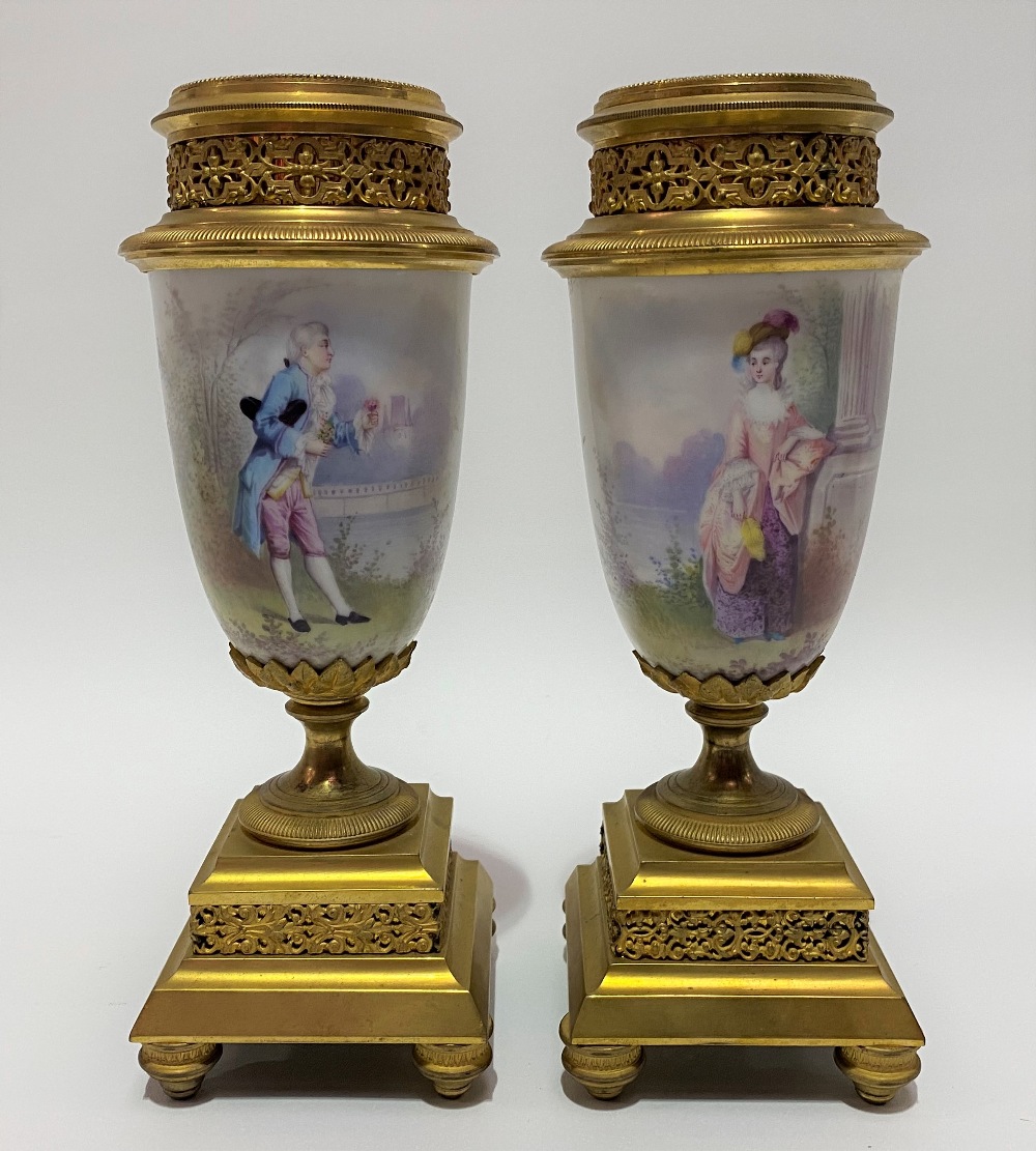 A pair of painted porcelain gilt bronze mounted pedestal garniture vases, the fluted & beaded collar