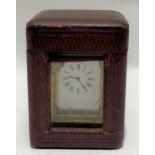 A French brass carriage timepiece with travel case, the 3.5cm white enamel dial with black roman