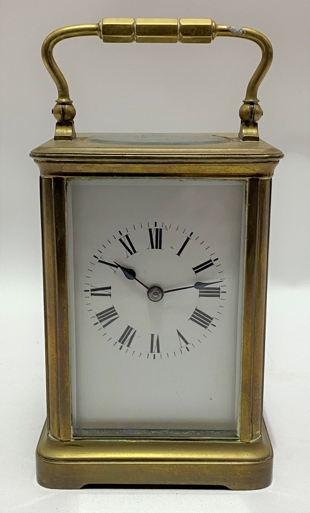 French brass cased carriage clock, the 2.5in white enamel dial with black Roman Numerals, the