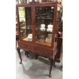 19th Century style walnut veneered display cabinet with pair of bevel glazed doors enclosing glass