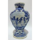 A Dutch Delft blue and white baluster relief moulded vase, decorated to one side with three