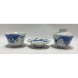 A Japanese blue and white lidded wine bowl with cover and saucer, underglaze blue decorated with