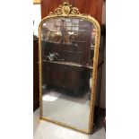 A 19th Century tall arched gilt gesso framed overmantle mirror with shield and ribbon scroll applied
