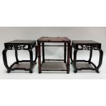 A pair of Chinese square section hardwood vase stands with foliate scroll carved frieze upon four