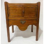 A George III mahogany night table with tray top over a pair of cupboard doors and a pull-out
