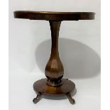 Victorian mahogany oval pedestal table with octagonal baluster support and oval plateau with four