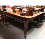 A Victorian mahogany rectangular dining table (no longer extending), raised on turned and fluted