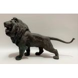 Japanese bronze model of a lion, impressed seal mark with characters to the case, length 48cm