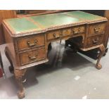 20th Century George II style walnut break front writing table, the top with triple green leather