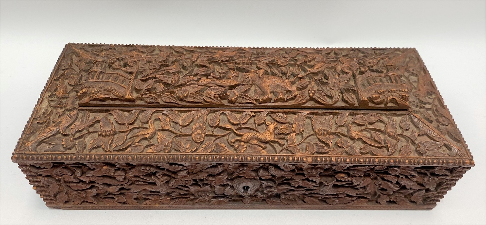 An Indian carved teak rectangular hinge lidded stationery box, with caddy top, the whole profusely - Image 2 of 2