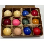 Set of eleven Victorian ivory billiard balls, one being crystalate, within a crystalate box