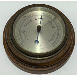 An aneroid barometer by Negretti & Zambra London, with 4.5 inch silvered dial within oak case.