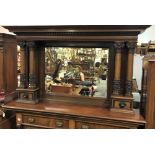 A Victorian mahogany overmantle mirror, the moulded and dentil cornice over the rectangular bevel