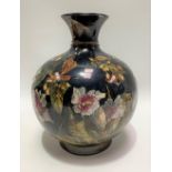 A Victorian Royal Doulton faience ovoid flared neck vase, foliate painted upon a dark blue ground,
