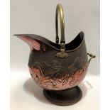 A Cornish Arts & Crafts copper and brass coal helmet, foliate scroll embossed, inscribed '