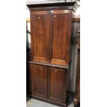 19th Century mahogany two-section estate cupboard, the pair of doors enclosing pigeonholes and three