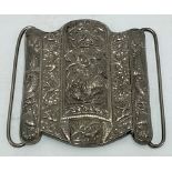 A Chinese export silver large buckle by Tien Shing, embossed with a Fo dog to the centre with a