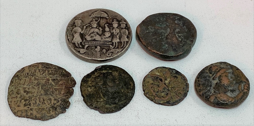 Collection of Roman coins and an Indian temple coin.