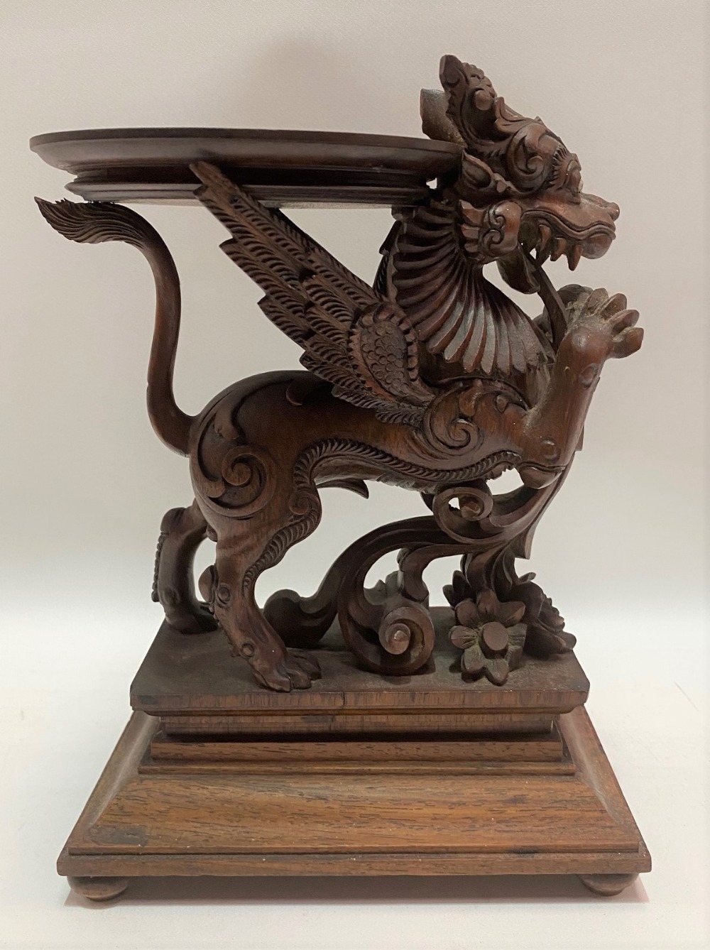 20th Century Burmese carved wood plant stand carved as a winged lion (Singa Bersayap) with mother of
