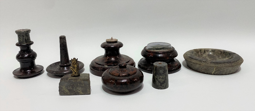 A collection of Cornish red serpentine wares including a candlestick (AF), a ring tree, a lidded