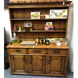 Reproduction oak dresser, the raised back with two shelves, the base with three drawers over three