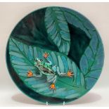 An Anita Harris studio wall charger in green glaze decorated with leaves and applied with a frog,