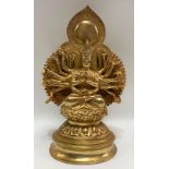 A gilt bronze Indo-Chinese votive sculpture of Ardhanarishvara in lotus position and on a stepped