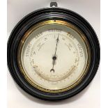 Aneroid barometer thermometer with 5.5in dial and within turned ebony frame, diameter overall 28cm
