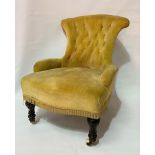 Victorian button-back nursing chair with turned and fluted fore legs with ceramic castors
