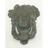 Neo-Classical style cast bronze door knocker in the form of a classical God head with leaf swag