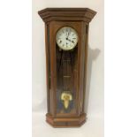 A modern mahogany cased three-train corner Vienna style wall clock by Wellingtonia Clocks,