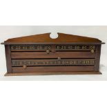An early 20th Century mahogany snooker scoreboard with broken arched top and gilt painted numerals