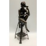 An Art Nouveau style bronze figure of a seated lady with cup, signed to seat J.E. Mic and numbered