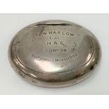 A Victorian white metal oval pinch activated tobacco box, the hinge lid with inscription, width 8.