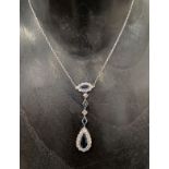 An attractive sapphire and diamond platinum set pendant necklace, the drop with a pear shaped sapphi