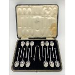 A cased set for twelve George V silver nail end tea spoons and sugar tongs, retailed by J.C.B.