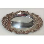 A Victorian silver oval pin tray with foliate scroll rim, maker J.R, Sheffield 1898, width 17.5cm,