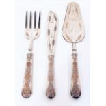 A silver weighted handled fish serving set comprising fork, slice and server, the handles embossed