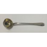 A continental white metal sauce ladle, of plain form and with interior gilded bowl, two punched