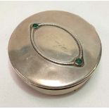 A white metal trinket box with hinged lid set with two green cabochon stones and with inscribed