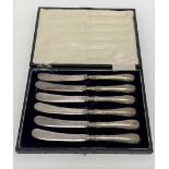 A cased set of six George V silver weighted handled butter knives, Sheffield 1911 (two af).