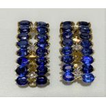 A pair of 9ct gold diamond and sapphire set clip earrings, length 24mm, weight 6g approx.